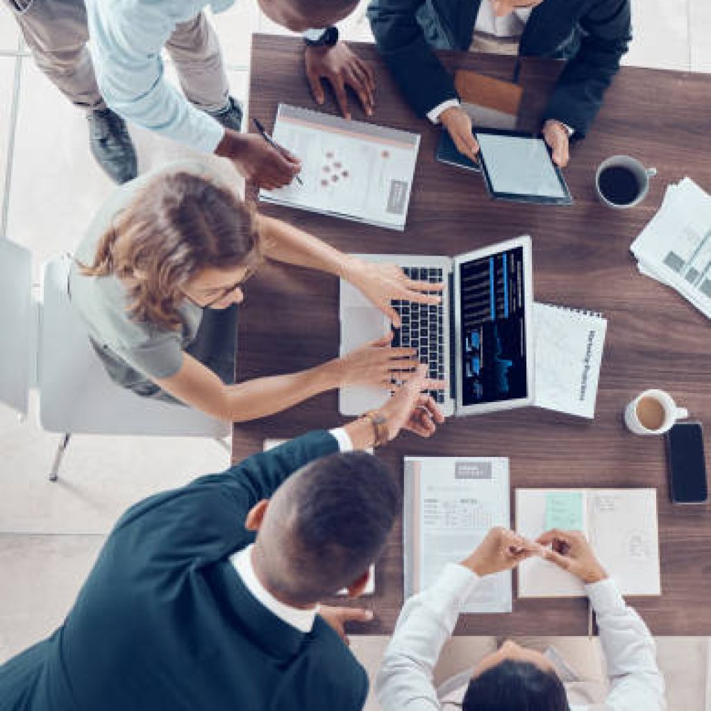 Planning, project management and marketing with business people in meeting for research, strategy and goals with laptop. Growth, analytics and collaboration with employees in corporate office